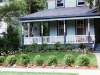 Plantings were kept low to accentuate the painted porch of this Victorian